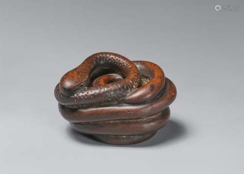 A large wood netsuke of a snake. Early 19th century