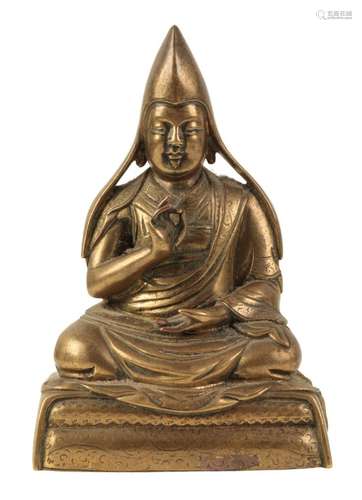 A SINO-TIBETAN BRONZE FIGURE OF A SEATED LAMA