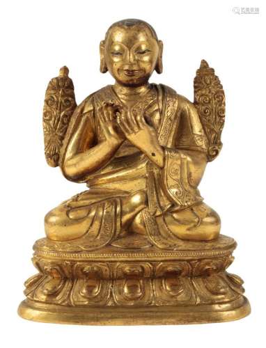 A SMALL SINO-TIBETAN GILT BRONZE OF A BUDDHIST MONK