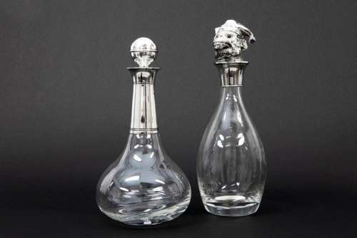 two decanters/claret jugs in glass, one 'novelty' with a mon...