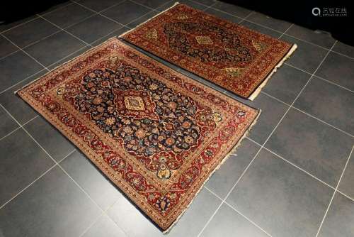two Persian Keshan rugs in wool with typical design on a blu...