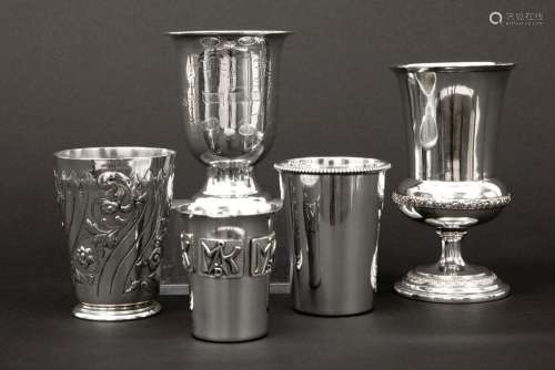 4 cups and a small vase in marked silver…