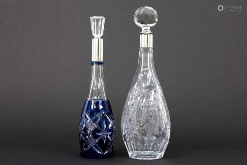 two decanters in crystal and marked silver…
