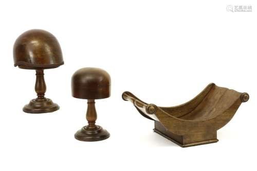 two wooden hat moulds on their stand and an 18th C…