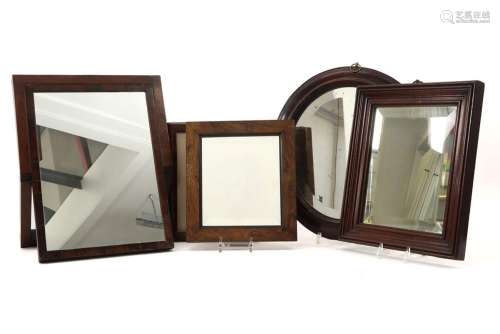 several antique wooden frames, mostly with a mirro…