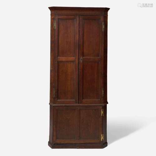 A George III carved oak corner cupboard late 18th century