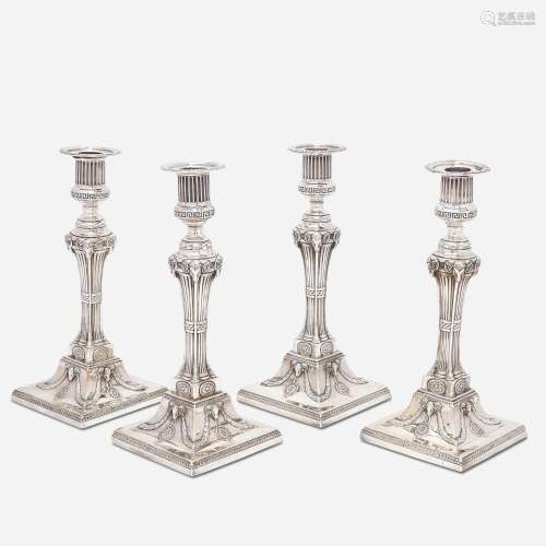 A set of four George III sterling silver weighted candlestic...