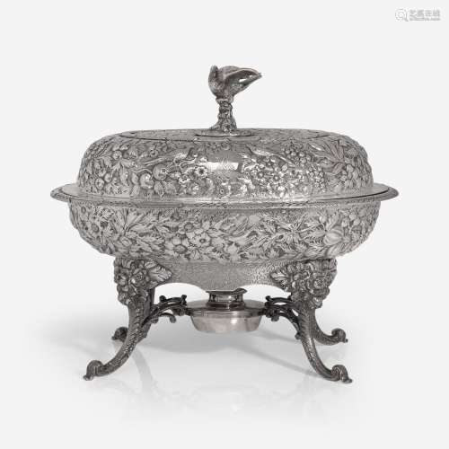 A coin silver floral repoussé covered warming dish on stand ...