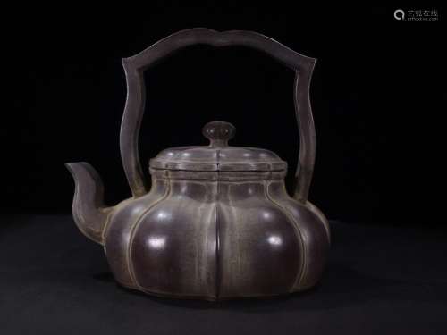 Old collection of old purple sand teapots with beams