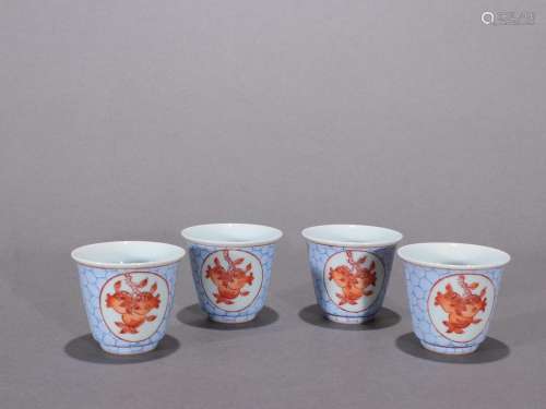 A group of bell cups with alum red glaze and pomegranate pat...