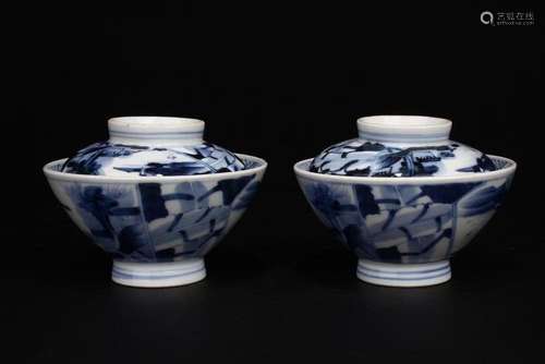 A pair of blue and white cups with landscape figures