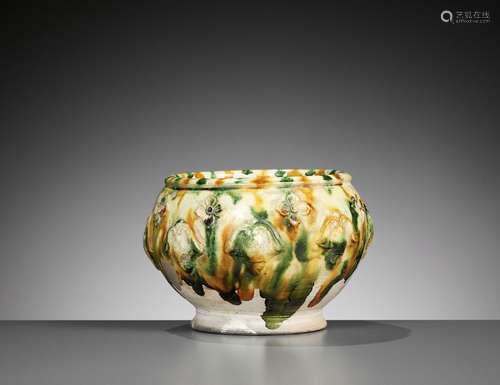 A SANCAI-GLAZED APPLIQUÉ-DECORATED POTTERY JAR, TANG DYNASTY