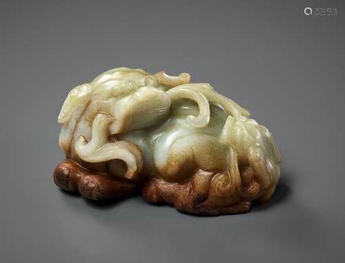 A CELADON AND RUSSET JADE ‘BUDDHIST LION AND CUB’ GROUP, 17T...