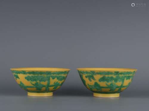 A pair of yellow-glazed and green-colored carved baby play b...