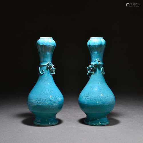 A pair of garlic vases with peacock blue glaze and dark engr...