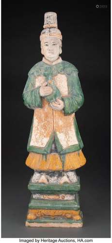 A Large Chinese Glazed Ceramic Standing Attendant