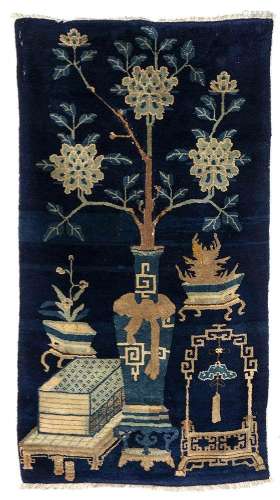 A BLUE GROUND CARPET WITH OBJECTS AND FLOWERS