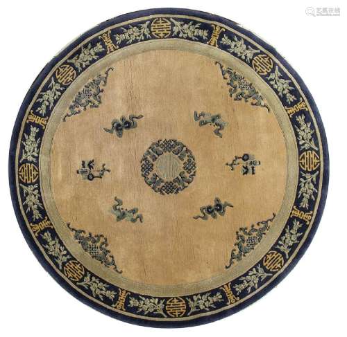 A OCHRE GROUND CIRCULAR CARPET WITH SHOU CHARACTER AND OBJEC...