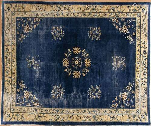 A BLUE GROUND CARPET WITH FLORAL MOTIFS