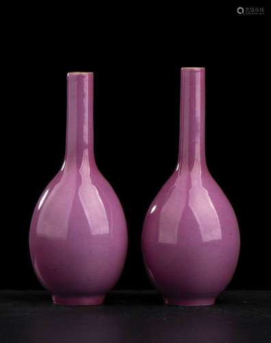 A PAIR OF RUBY GLAZED PORCELAIN SMALL BOTTLE VASES