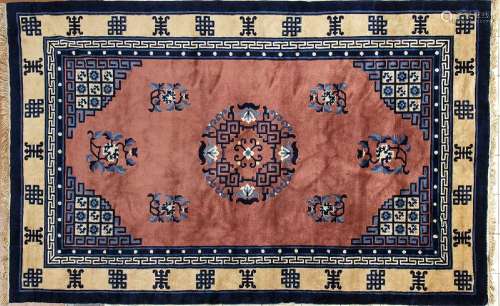 A PINK GROUND CARPET WITH A POLYCHROME DECORATION OF CHARACT...