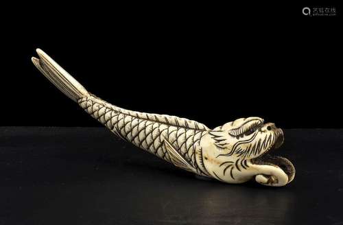 A STAG HORN NETSUKE WITH A FANTASTIC ANIMAL