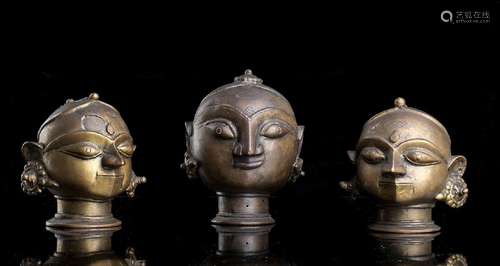 THREE BRONZE HEADS OF FEMALE DEITIES