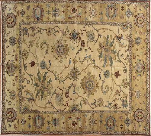 AN OCHRE GROUND CARPET WITH FLORAL MOTIFS