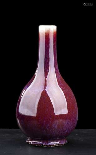 A ‘SANG DE BOEUF’ GLAZED PORCELAIN BOTTLE VASE