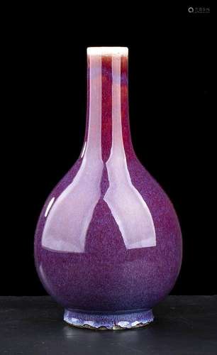 A ‘SANG DE BOEUF’ GLAZED PORCELAIN BOTTLE VASE