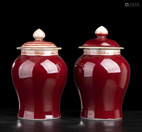 A PAIR OF ‘SANG DE BEOUF’ GLAZED PORCELAIN VASES AND COVER