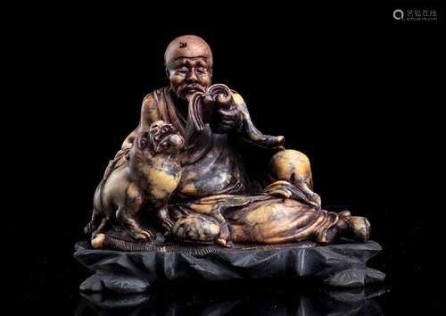 A SOAPSTONE SCULPTURE OF A LOHAN AND TIGER