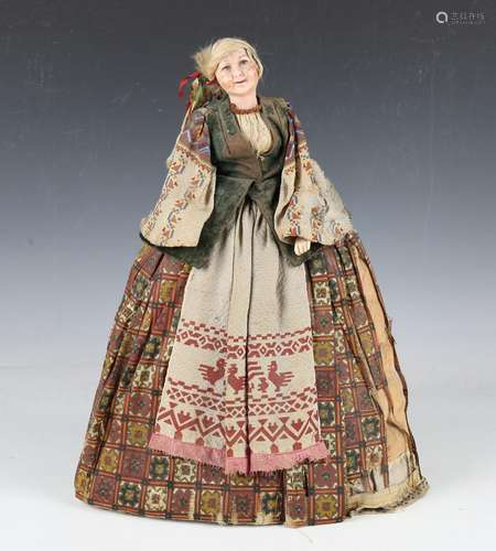 A wax head and shoulders 'Russian' tea cosy doll with plaite...