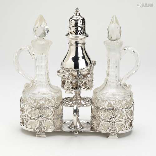 A Dutch silver cruet set with cut-glass flasks and silver ca...