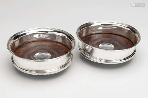 A pair of English silver and wood wine coasters