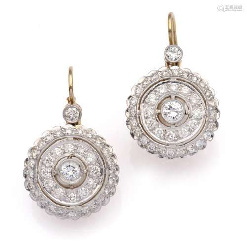 A pair of platinum and 14k gold diamond earrings