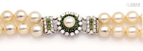 An 18k white gold cultured pearl, emerald and diamond neckla...