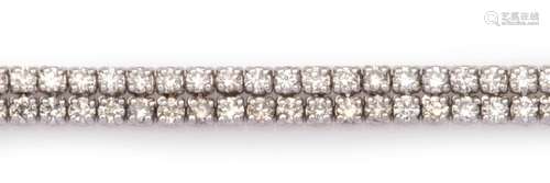 An 18k white gold diamond line bracelet