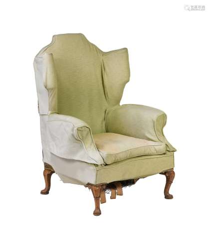 A WALNUT AND UPHOLSTERED WING ARMCHAIRIN GEORGE II STYLE