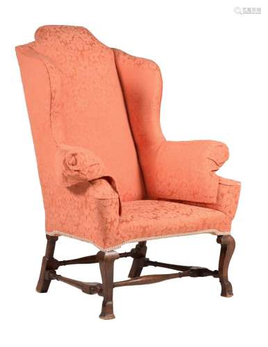 A WALNUT AND UPHOLSTERED WING ARMCHAIR IN WILLIAM & MARY...