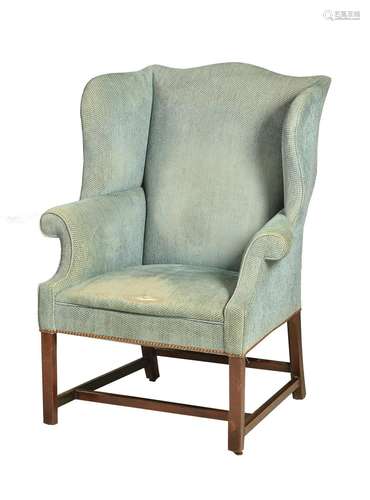 A MAHOGANY AND UPHOLSTERED WING ARMCHAIR