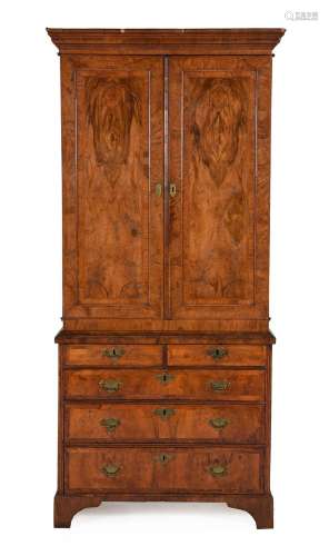 A WALNUT AND FEATHER BANDED CABINET ON CHEST
