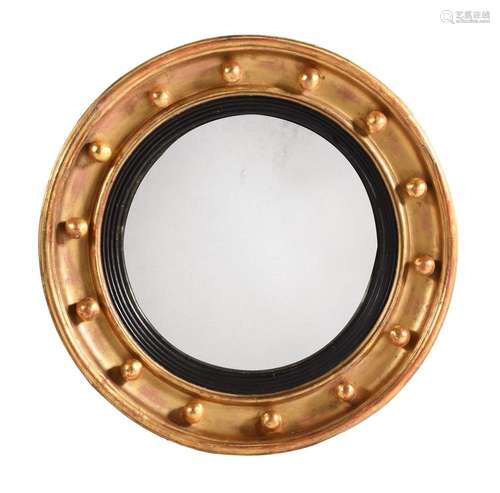 A GILTWOOD CONVEX WALL MIRROR