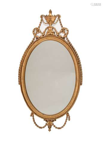 A GILTWOOD AND COMPOSITION OVAL WALL MIRROR IN GEORGE III ST...