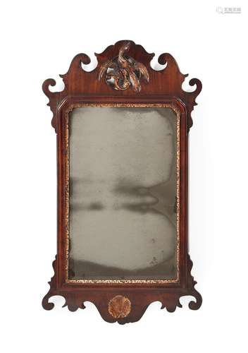 A GEORGE II WALNUT AND PARCEL GILT FRET WALL MIRROR