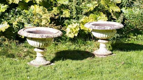 A PAIR OF CAST IRON URNS