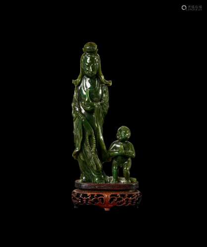A FINE CHINESE DEEP SPINACH JADE FIGURE OF GUANYIN AND ATTEN...