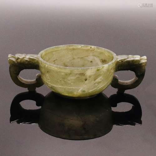 A CHINESE TWIN HANDLE SPINACH JADE CUP, QING DYNASTY (1644-1...