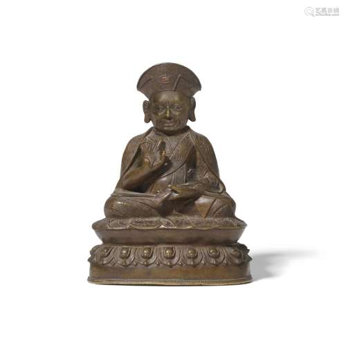 A CAST AND CHASED BRONZE FIGURE OF A KAGYU LAMA Tibet, 16th ...