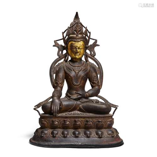 A GILT-BRONZE SEATED FIGURE OF AKSOBHYA BUDDHA  Tibet, 13th/...